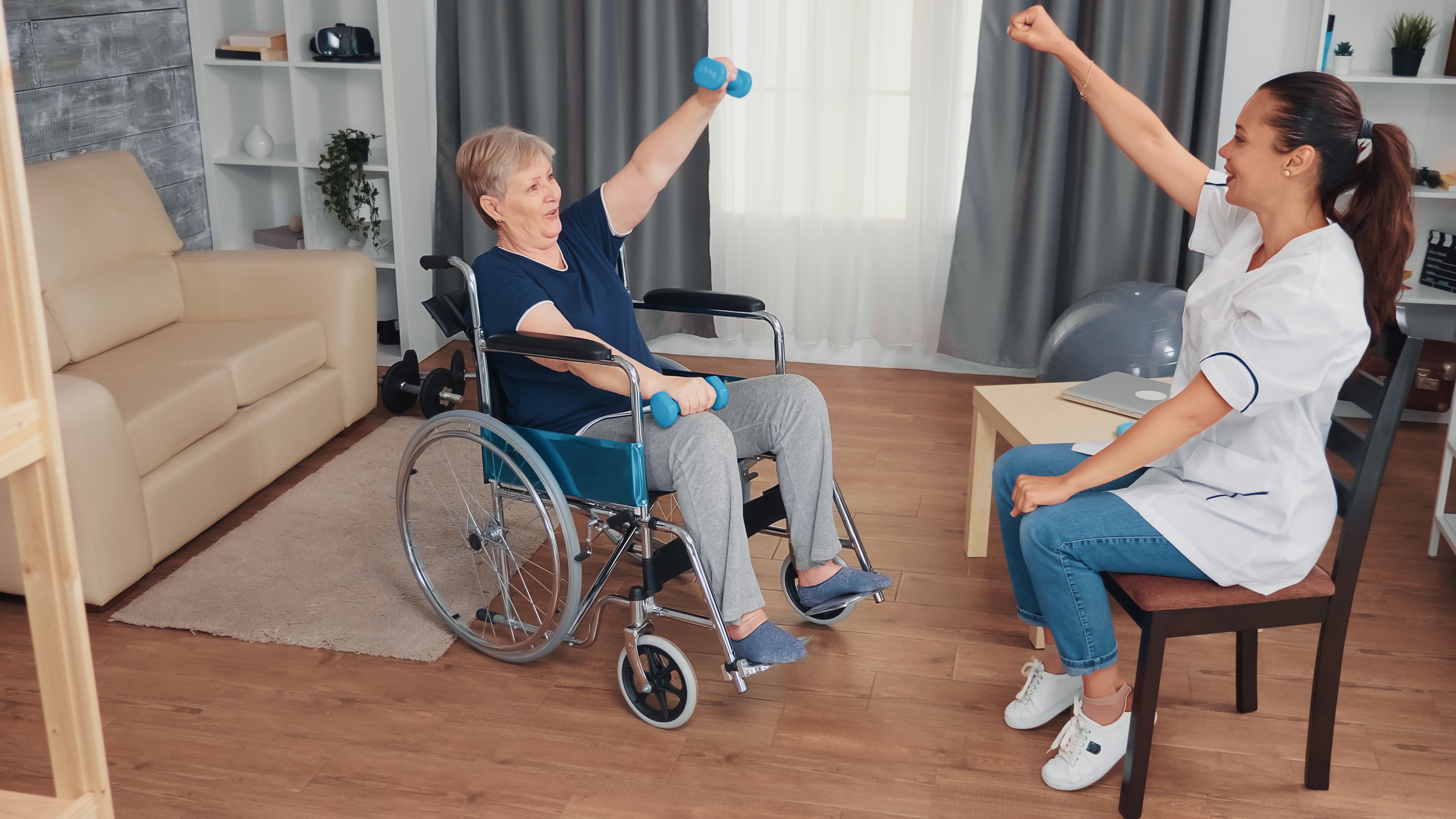elderly lady exercising in wheelchair with dumbbells